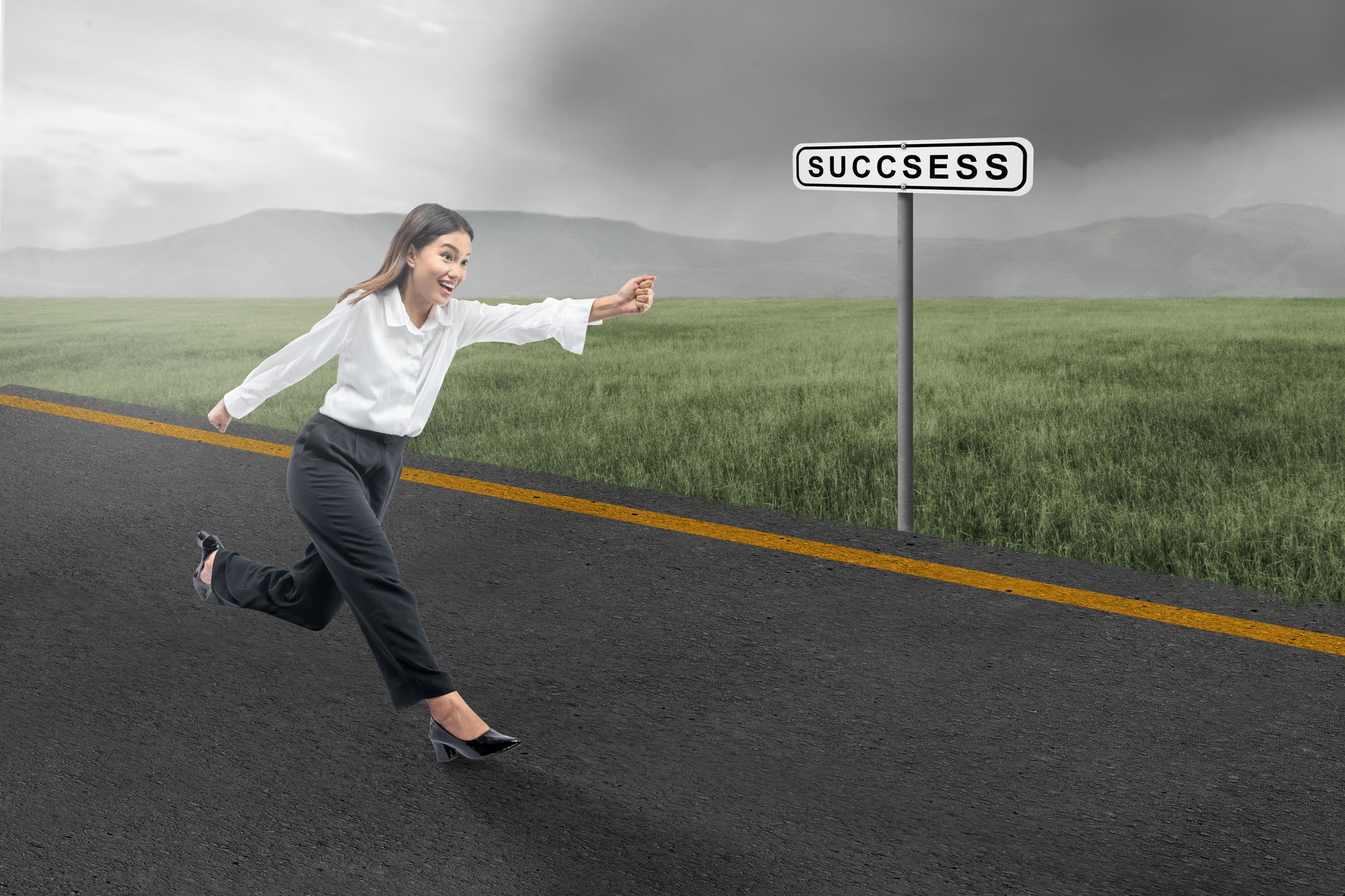 Asian businesswoman running on the street with a success sign